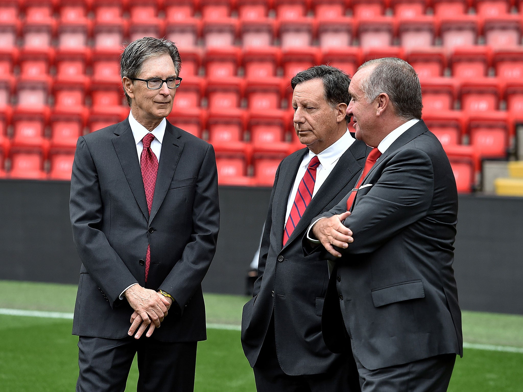 Ayre (right) alongside Liverpool owner John W Henry (left) and chairman Tom Werner (centre)