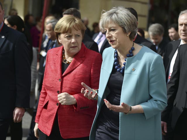 Theresa May chats with Angela Merkel on a walkabout in Malta