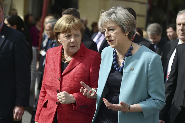 Theresa May chats with Angela Merkel on a walkabout in Malta