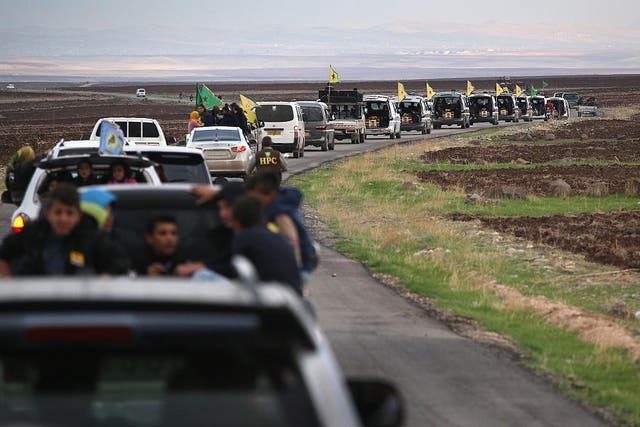 A funeral procession carries eight members of the People's Protection Units (YPG), to a martyrs' cemetery on November 8, 2015 in Rojava, Syria. The YPG are among several forces pushing Isis back towards their stronghold of Raqqa.