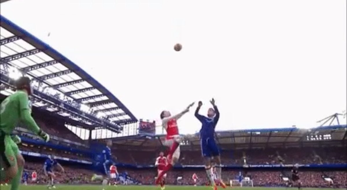 Hector Bellerin and Marcos Alonso both jump for a header