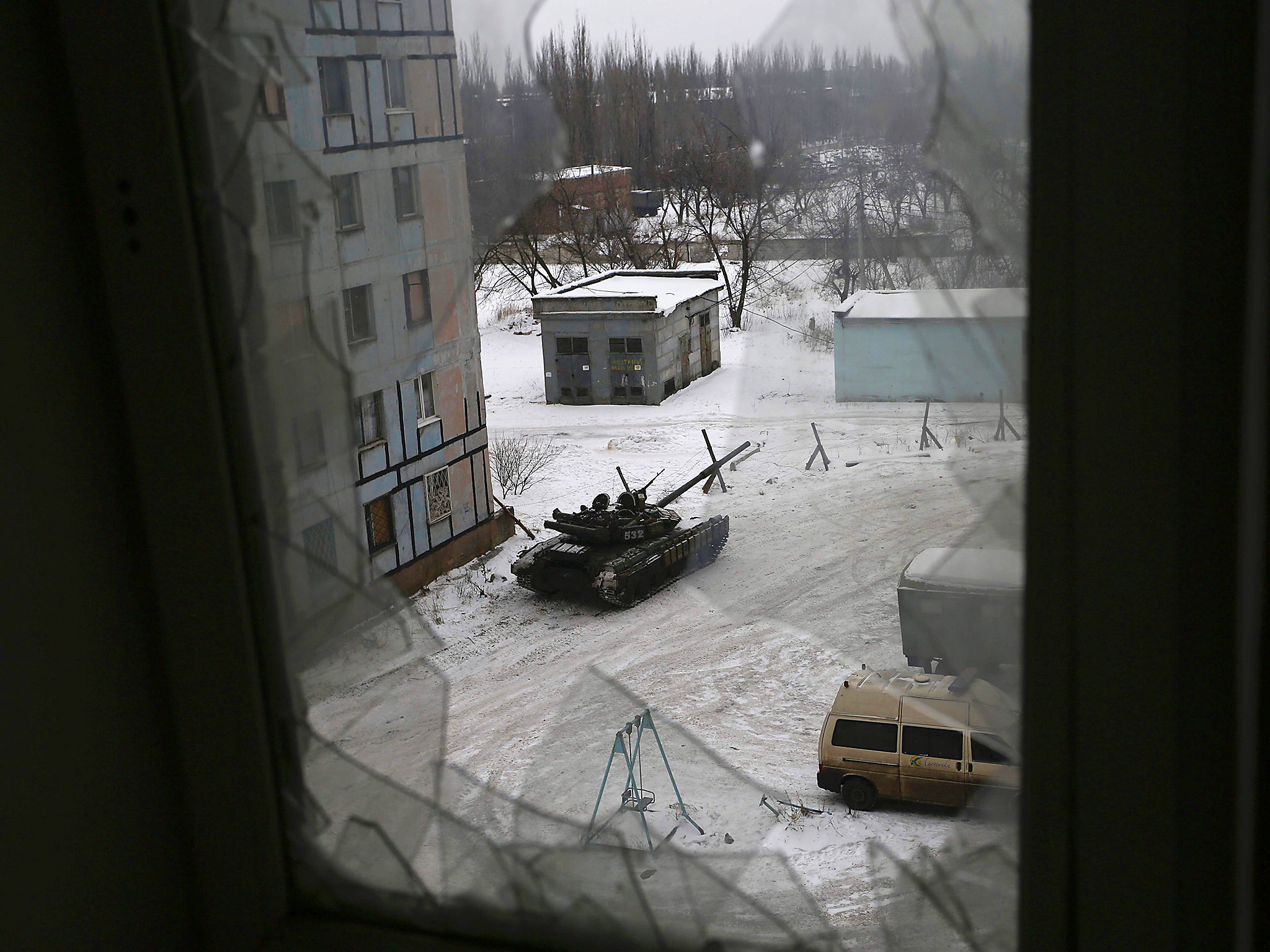 A tank from the Ukrainian Forces is stationed outside a building in the flashpoint eastern town of Avdiivka that sits just north of the pro-Russian rebels' de facto capital of Donetsk
