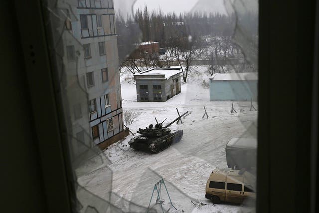 A tank from the Ukrainian Forces is stationed outside a building in the flashpoint eastern town of Avdiivka that sits just north of the pro-Russian rebels' de facto capital of Donetsk