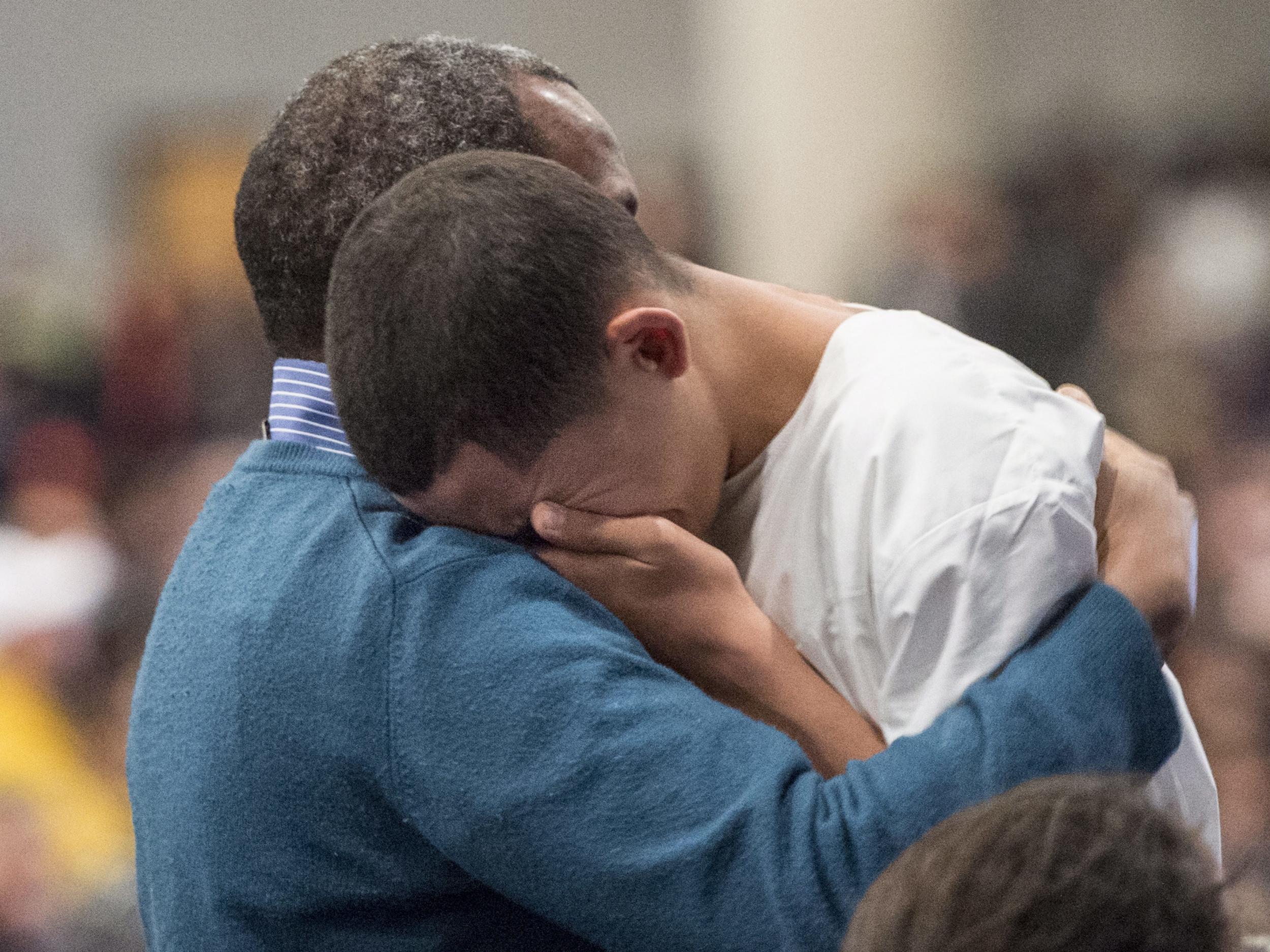 Ilies Soufiane, fifteen year old son of victim Azzeddine Soufiane, is consoled during a ceremony for three of the six victims of the Quebec City mosque shooting