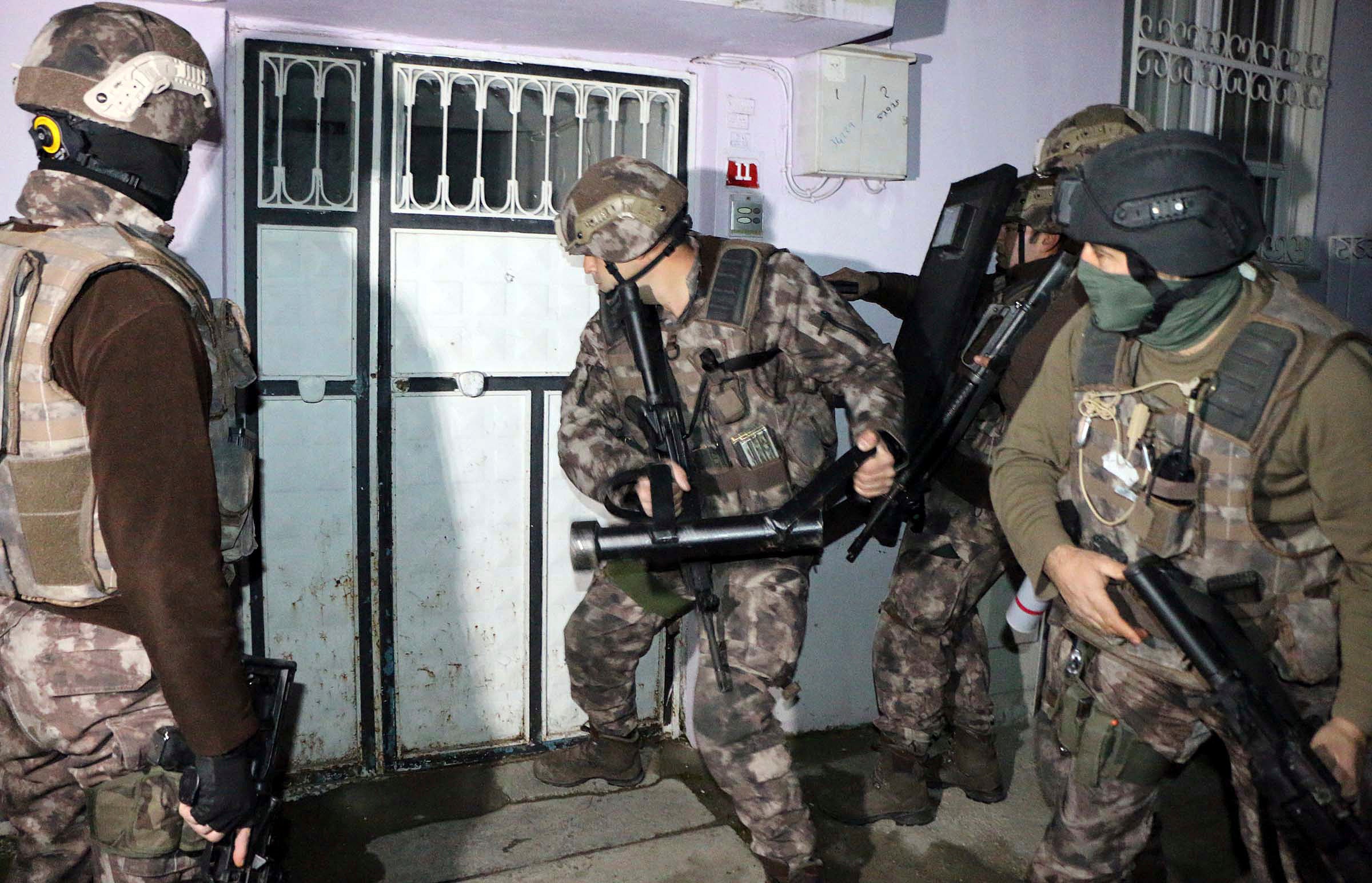 Turkish anti-terrorism police break a door during an operation to arrest people over alleged links to Isis in Adiyaman, southeastern Turkey, during which more than 400 suspects were detained