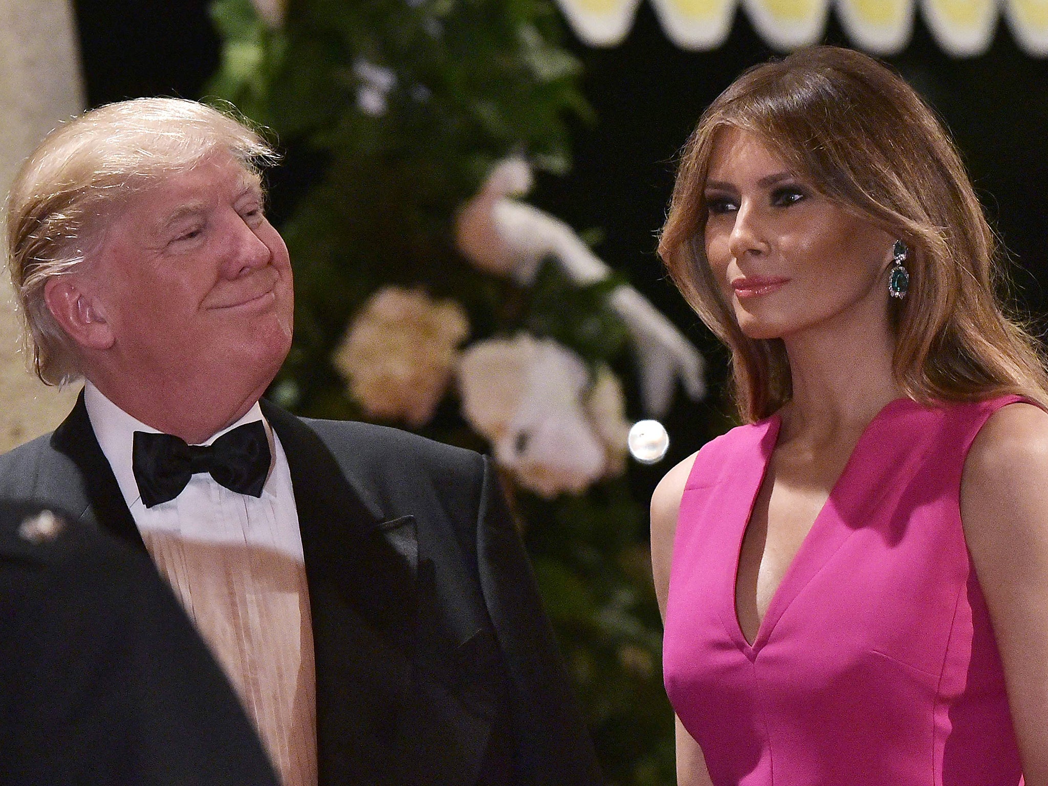 US President Donald Trump and First Lady Melania Trump arrive for the 60th Annual Red Cross Gala at his Mar-a-Lago estate in Palm Beach