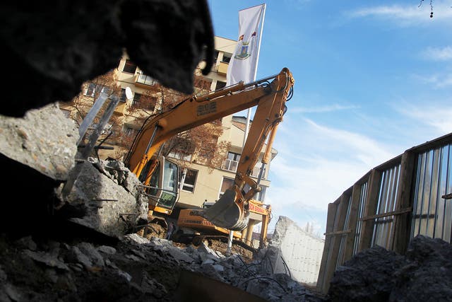 Bulldozers demolish a wall following weeks of tensions between Kosovo and Serbia, in the ethnically divided town of Mitrovica, Kosovo