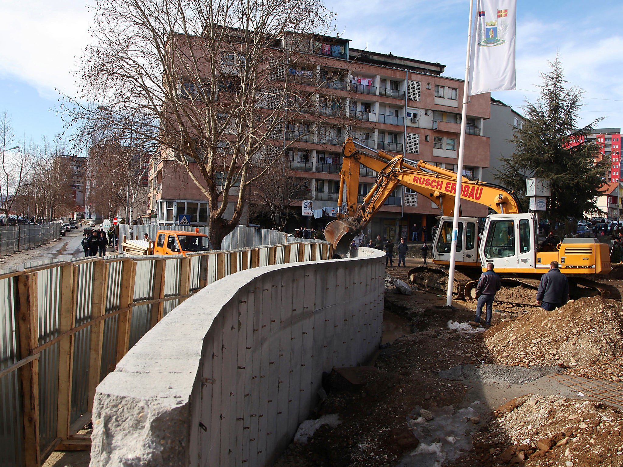 Bulldozers demolish a wall following weeks of tensions between Kosovo and Serbia, in the ethnically divided town of Mitrovica, Kosovo