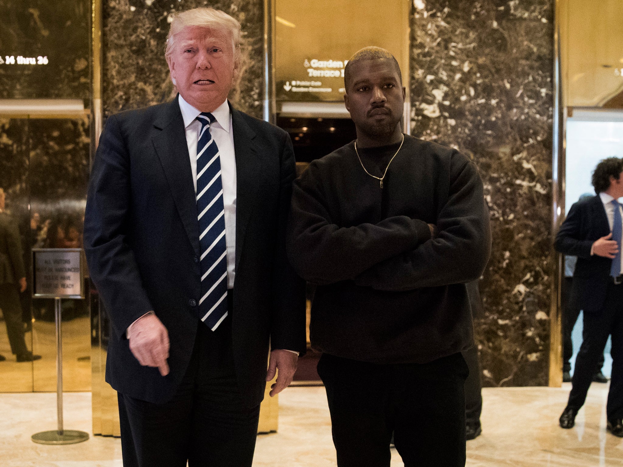 Trump and West stand in the lobby of Trump Tower in Manhattan