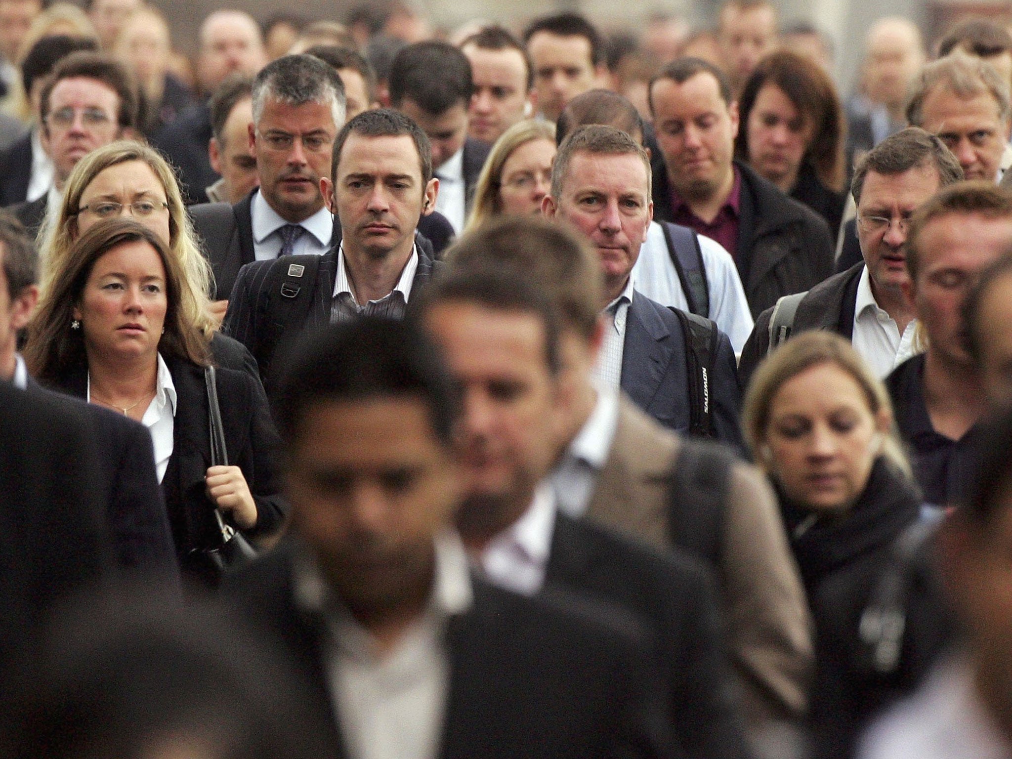 Commuters walk to work over London Bridge