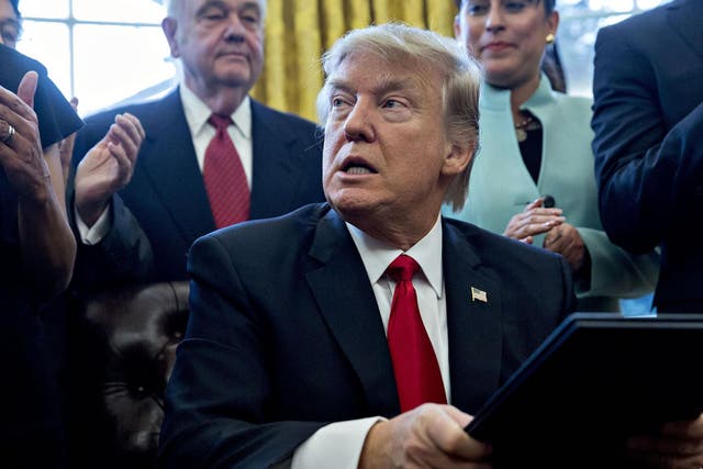 President Trump sings an executive order in the Oval Office on January 30, 2017 in Washington, DC.