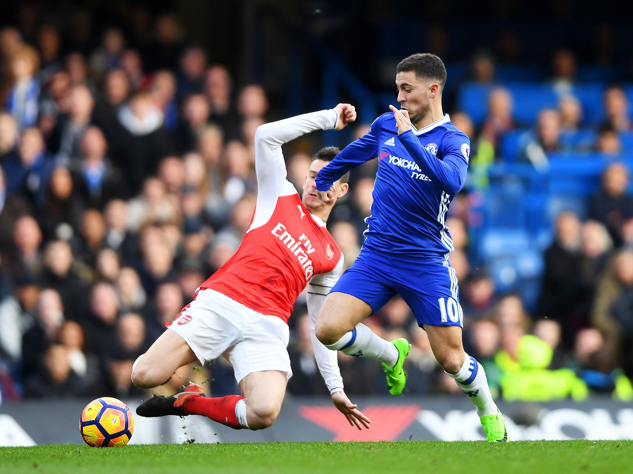 Eden Hazard attempts to take the ball past Arsenal's Laurent Koscielny during Saturday's game