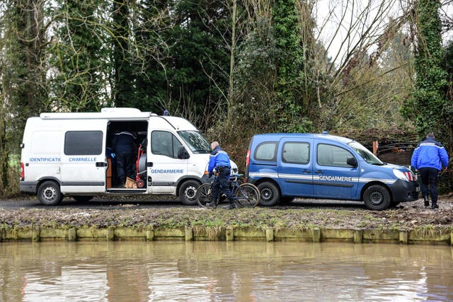 French gendarmes investigate near a channel in Aire-sur-la-Lys on February 6, 2017. A 5-year-old child died overnight in dubious circumstances leading to a remand in custody of his parents