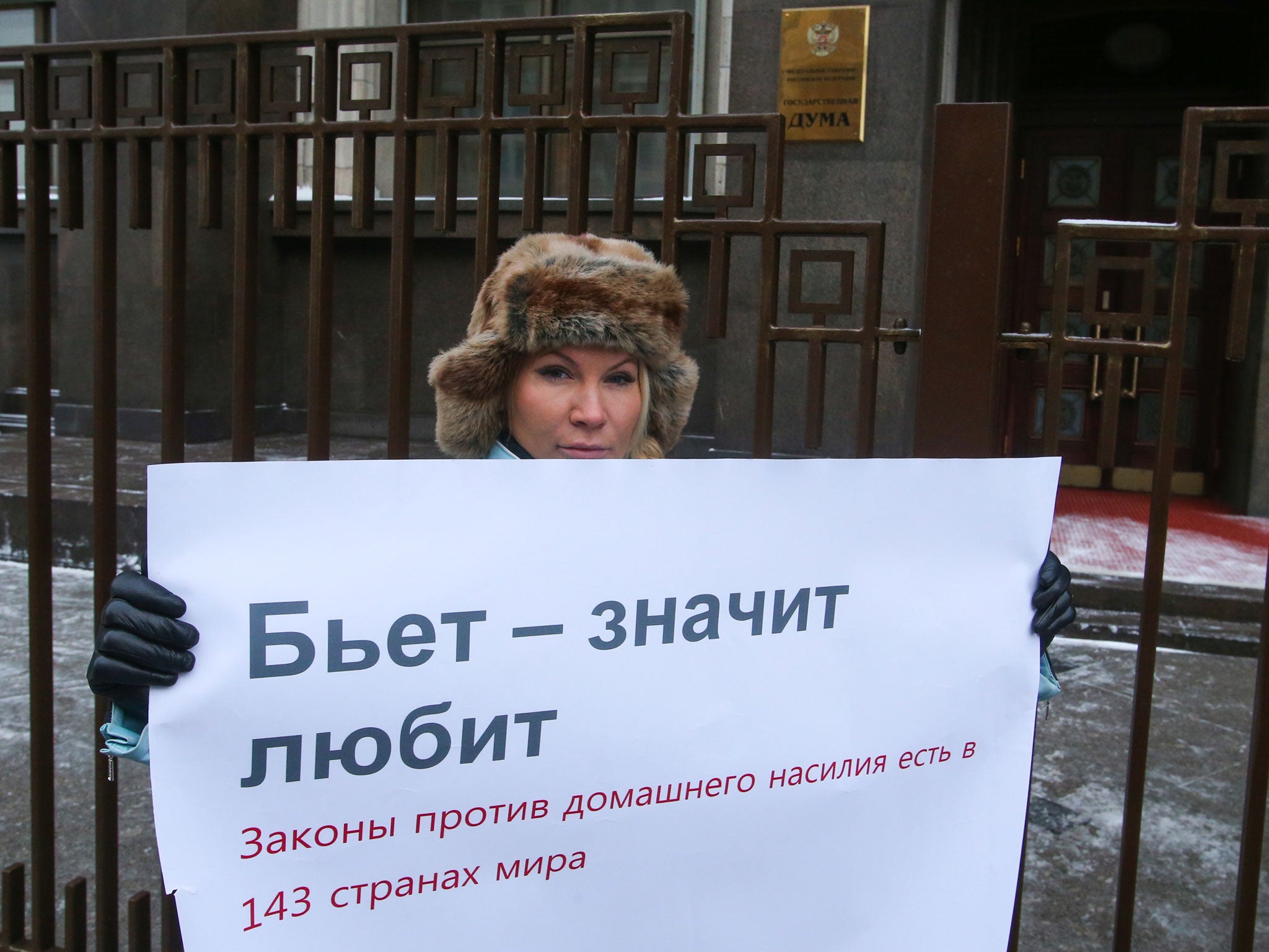 Alena Popova, a human rights activist, stages a lone protest against a Russian State Duma bill reducing punishment for domestic violence