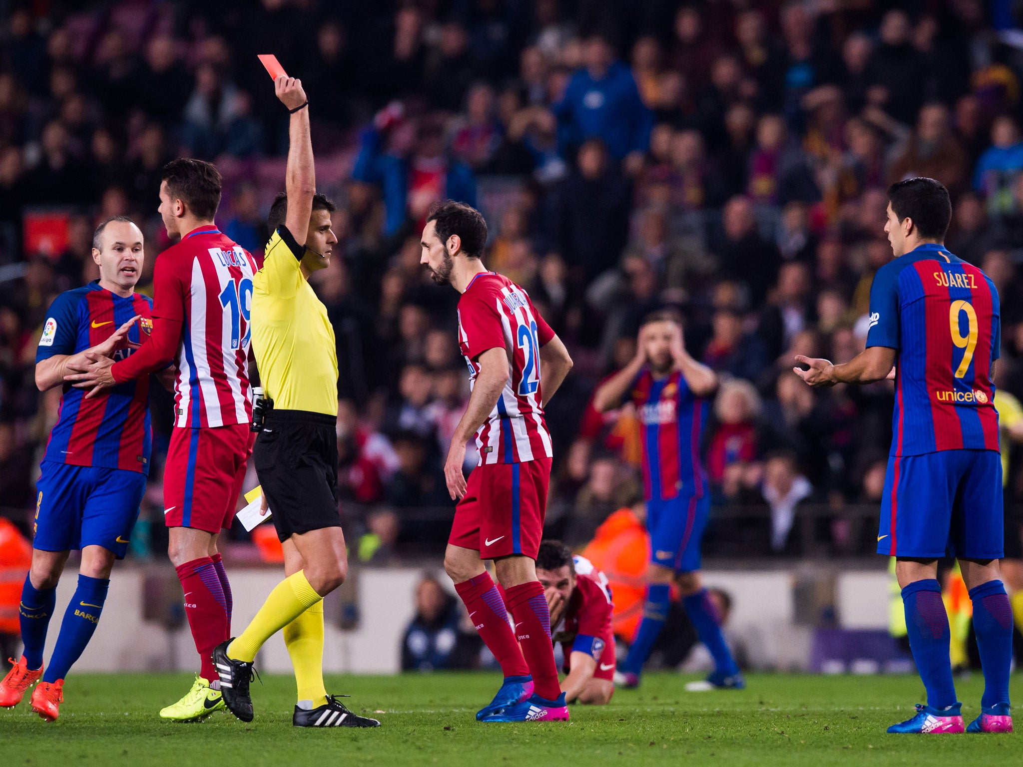 Referee Jesus Gil Manzano shows Suarez a straight red card