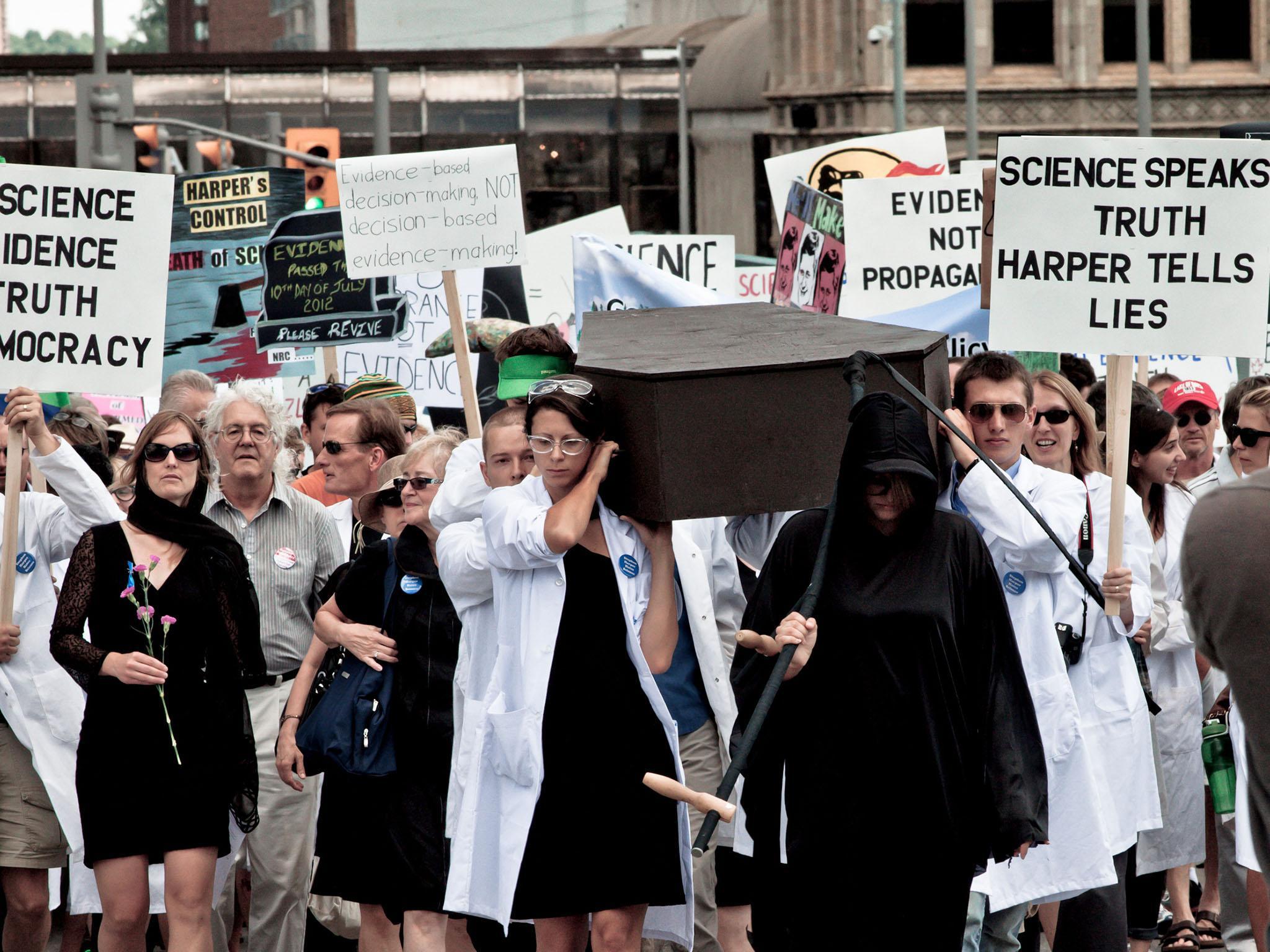 Rage of reason: hundreds of scientists hold a mock funeral for the ‘death of scientific evidence’ outside the Canadian parliament in July 2012