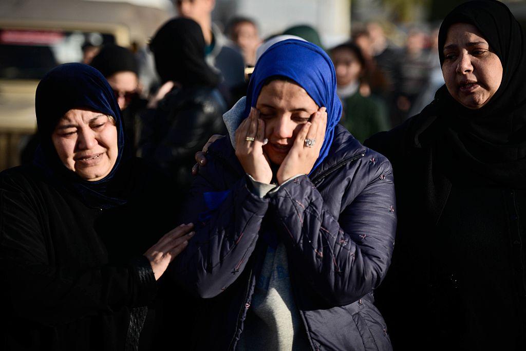 Relatives of members of the Egyptian security forces killed in North Sinai in an Isis attack wait for the bodies of their loved ones at Cairo airport on January 30 2015