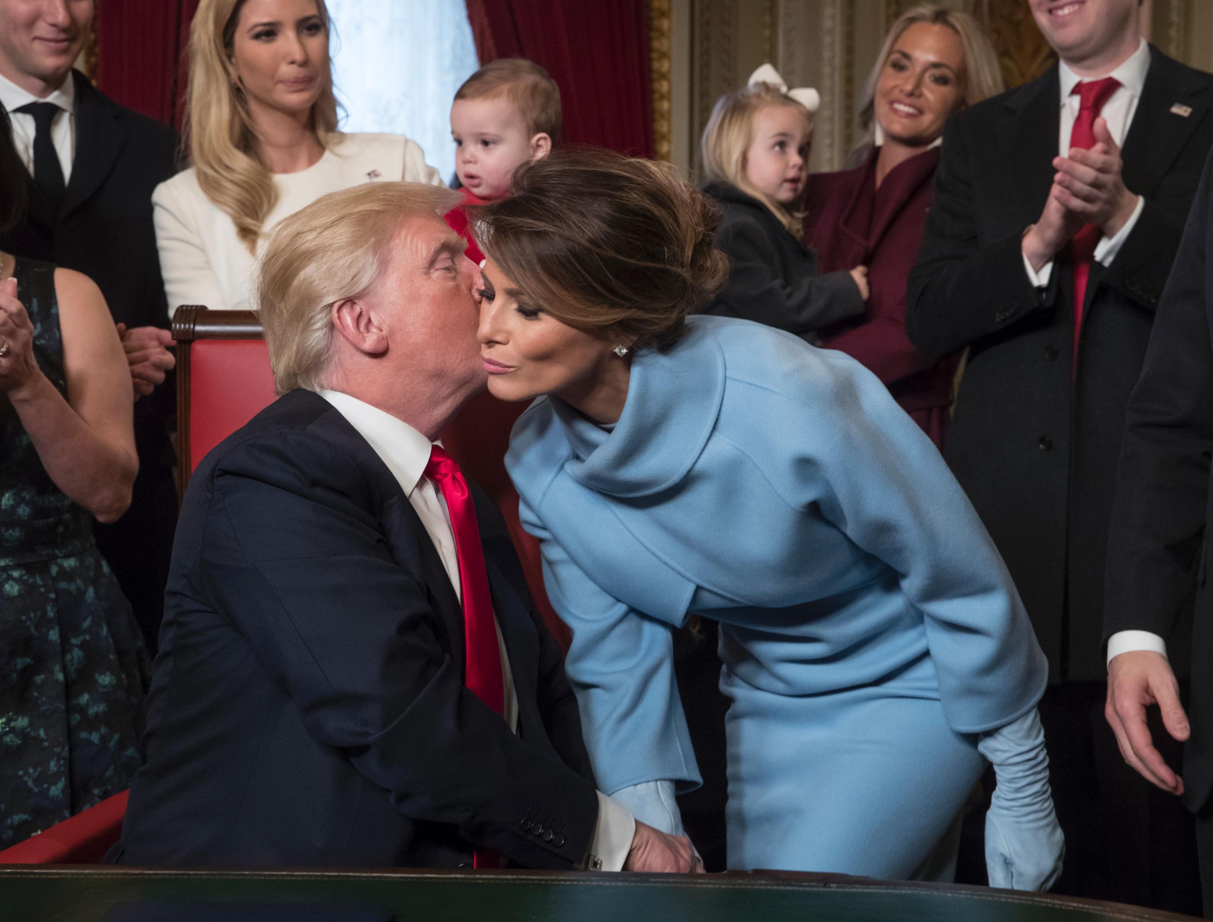 US President Donald Trump kisses his wife Melania Trump