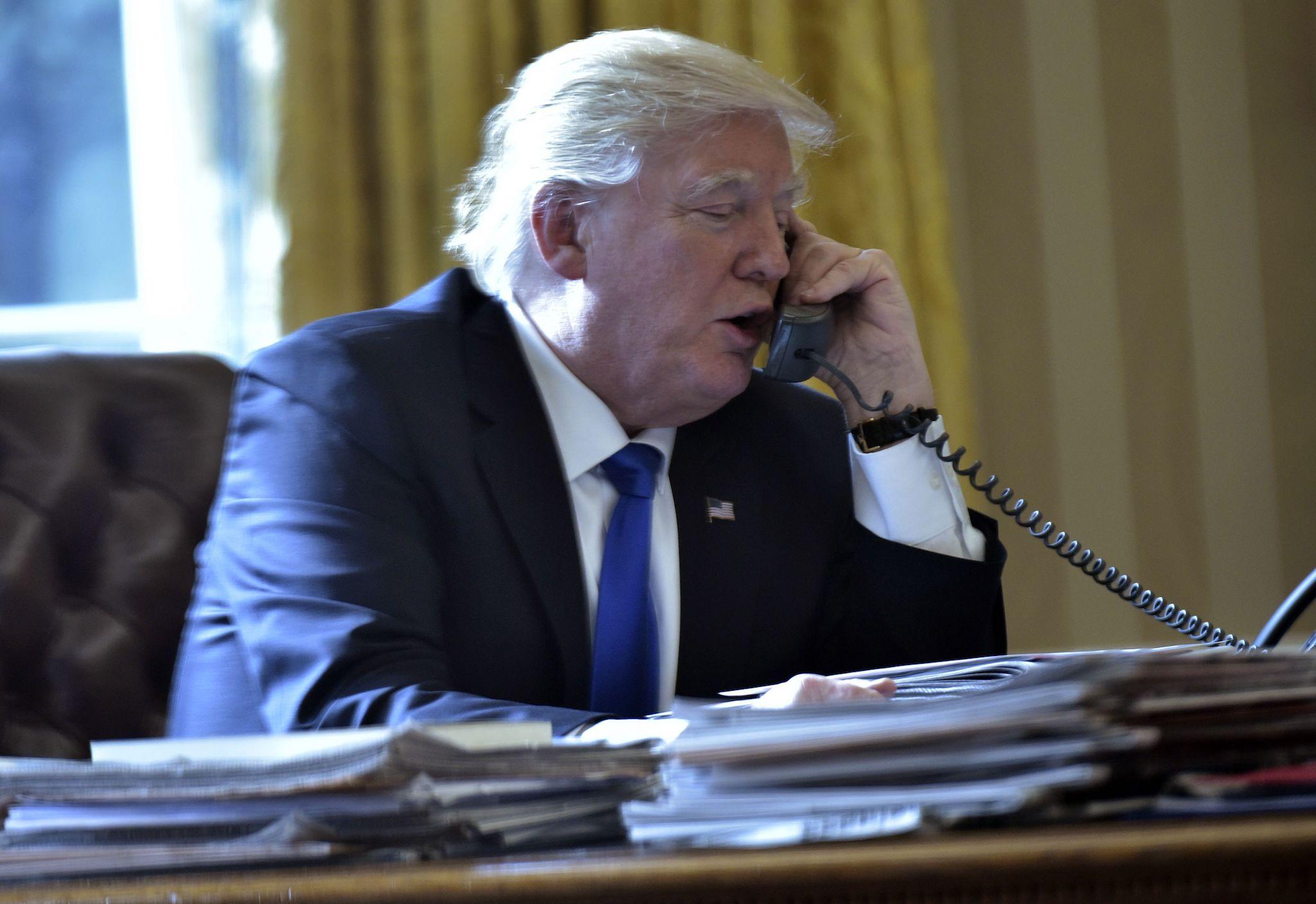 US President Donald Trump speaks on the phone with Russia's President Vladimir Putin from the Oval Office of the White House on January 28, 2017