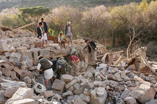 Yemenis inspect damaged houses following reported Saudi-led coalition air strikes on the outskirts of the Yemeni capital Sana’a