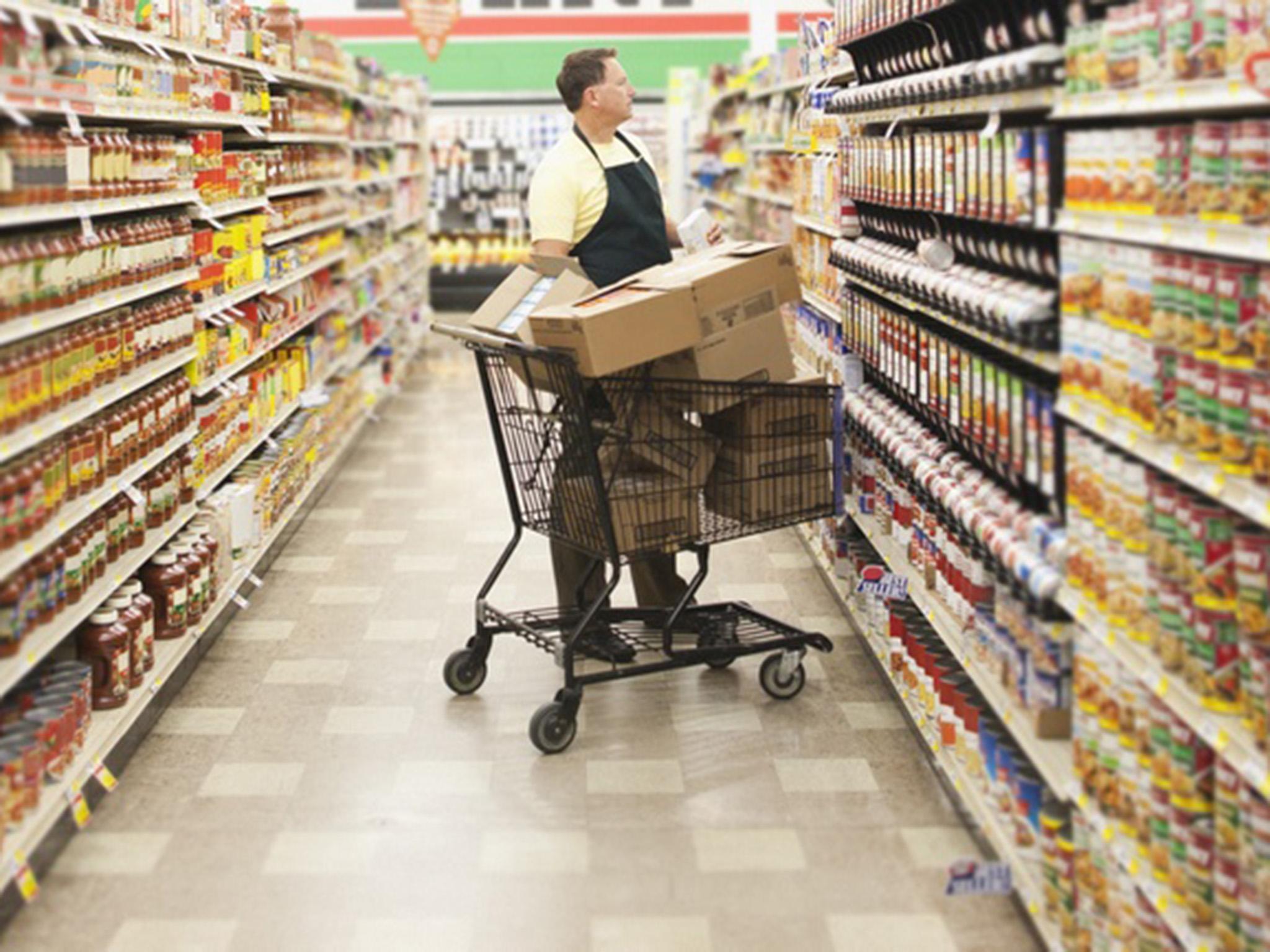 A supermarket worker stocks shelves