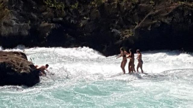 The four women became trapped on a small rock in the middle of the river as the water level began to rise