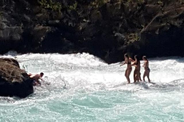The four women became trapped on a small rock in the middle of the river as the water level began to rise