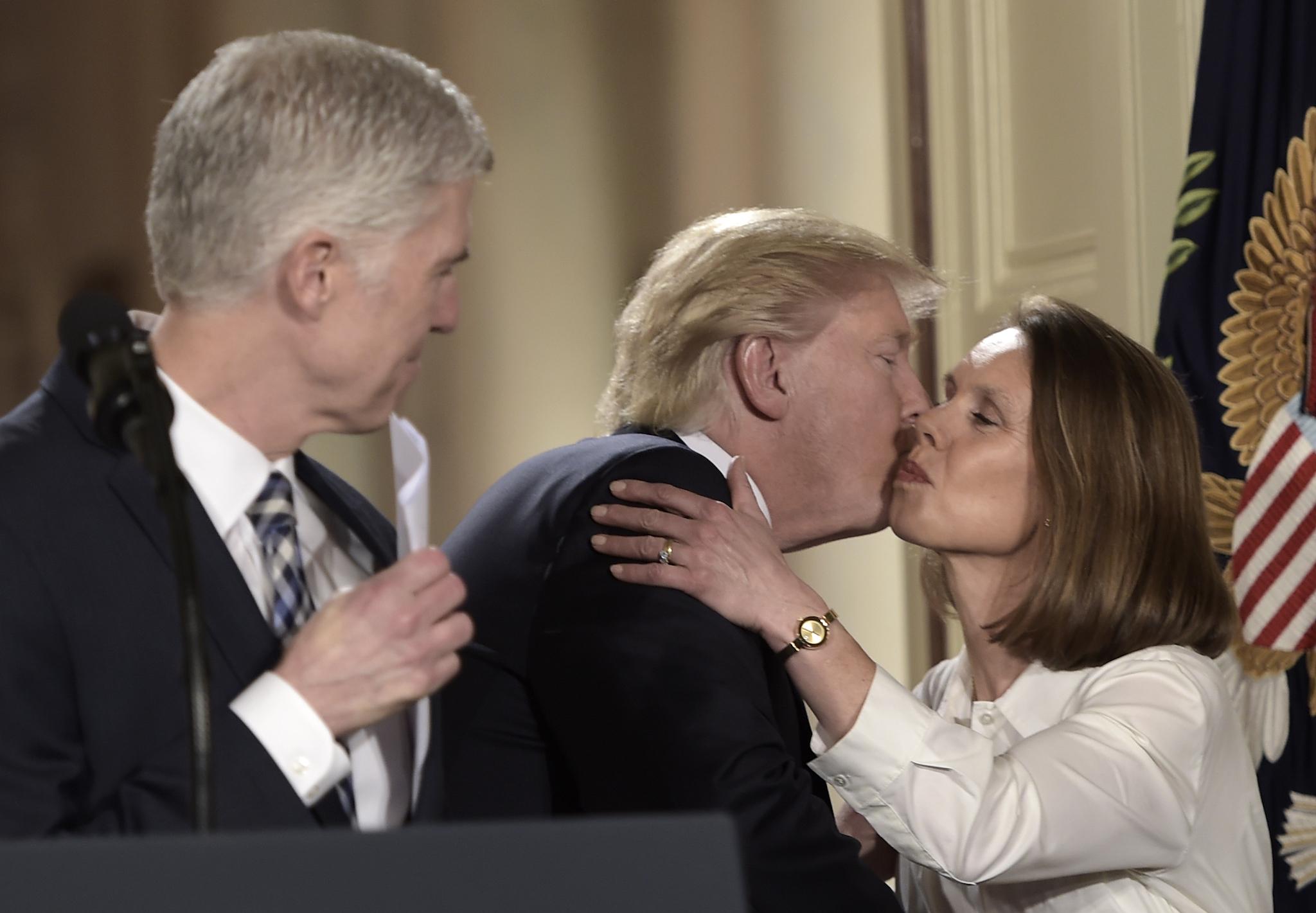 US President Donald Trump (C) greets Marie Louise, the wife of Judge Neil Gorsuch (L), after Trump nominated Gorsuch for the Supreme Court, at the White House in Washington, DC, on January 31, 2017