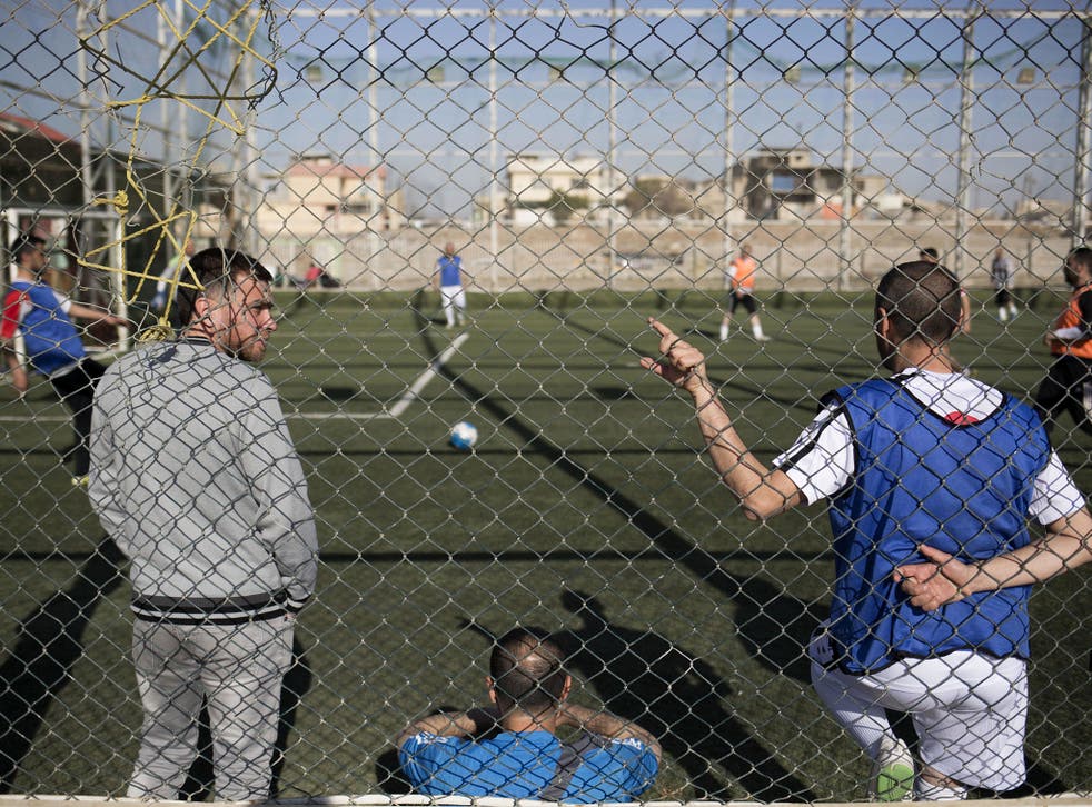 In this Wednesday, 8 February 2017 photo, Mosul residents play soccer on a pitch in the liberated eastern part of the city