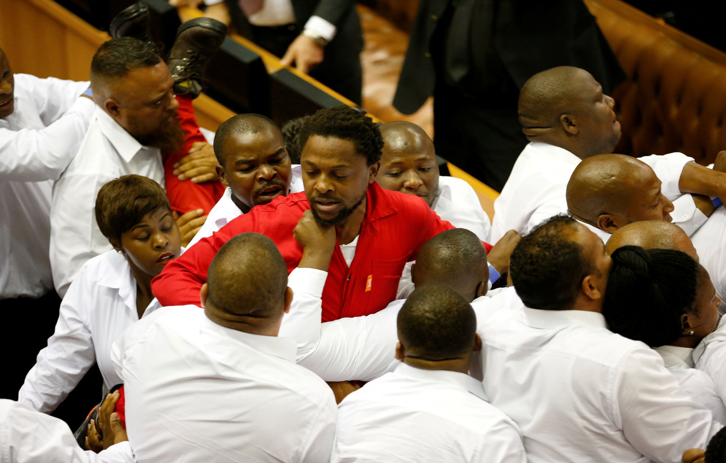 Security officials remove members of the Economic Freedom Fighters in the South African parliament
