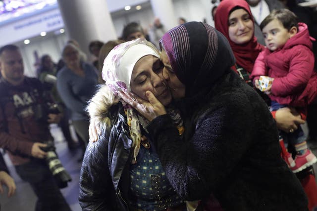 Syrian refugee Baraa Haj Khalaf receives a kiss from her mother Fattoum Haj Khalaf at O'Hare International Airport on February 7, 2017 in Chicago, Illinois.