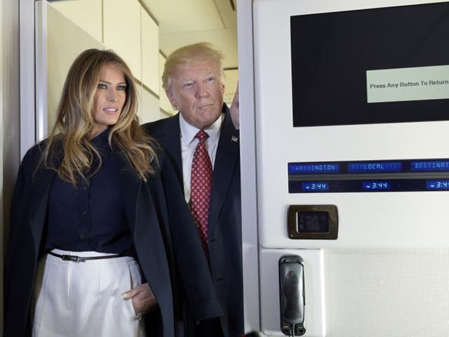 Donald Trump and first lady Melania talk with reporters on board Air Force One white travelling to Palm Beach, Florida