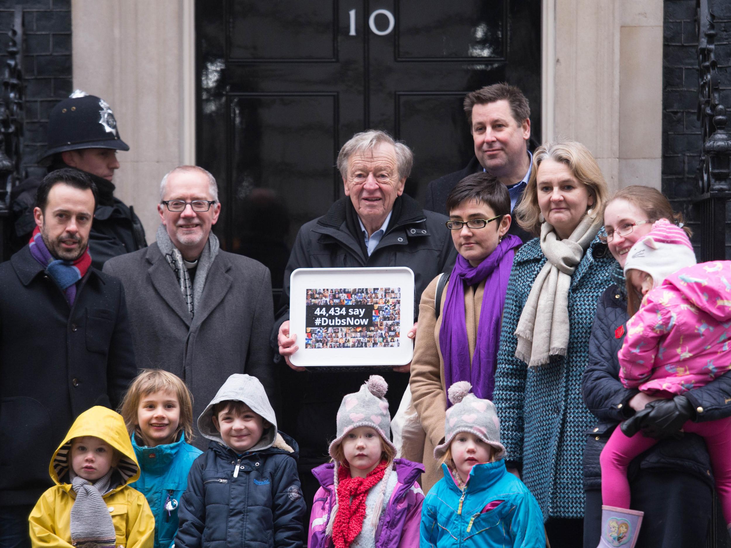 Labour peer Lord Dubs accompanied by religious and community leaders and foster carers