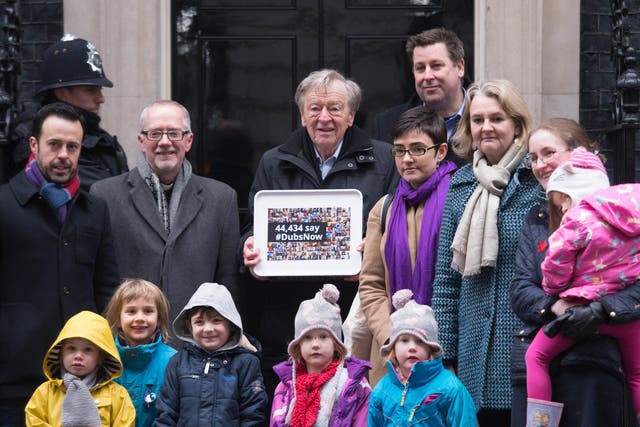Labour peer Lord Dubs accompanied by religious and community leaders and foster carers