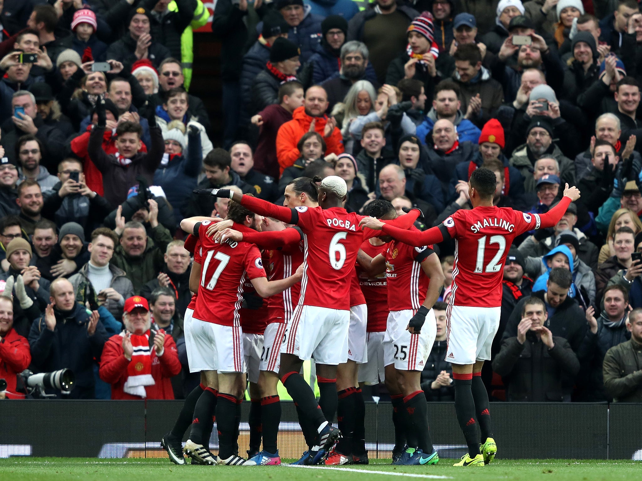 Manchester United's players celebrate Mata opening the scoring at Old Trafford