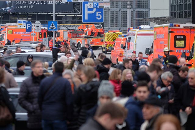 Travellers wait outside the Hamburg after after several people were injured by an unknown toxic that likely spread through the airports’ air conditioning system.