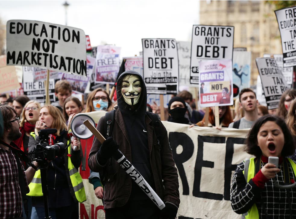 Students during a protest calling for the abolition of tuition fees and an end to student debt in Westminster, London.