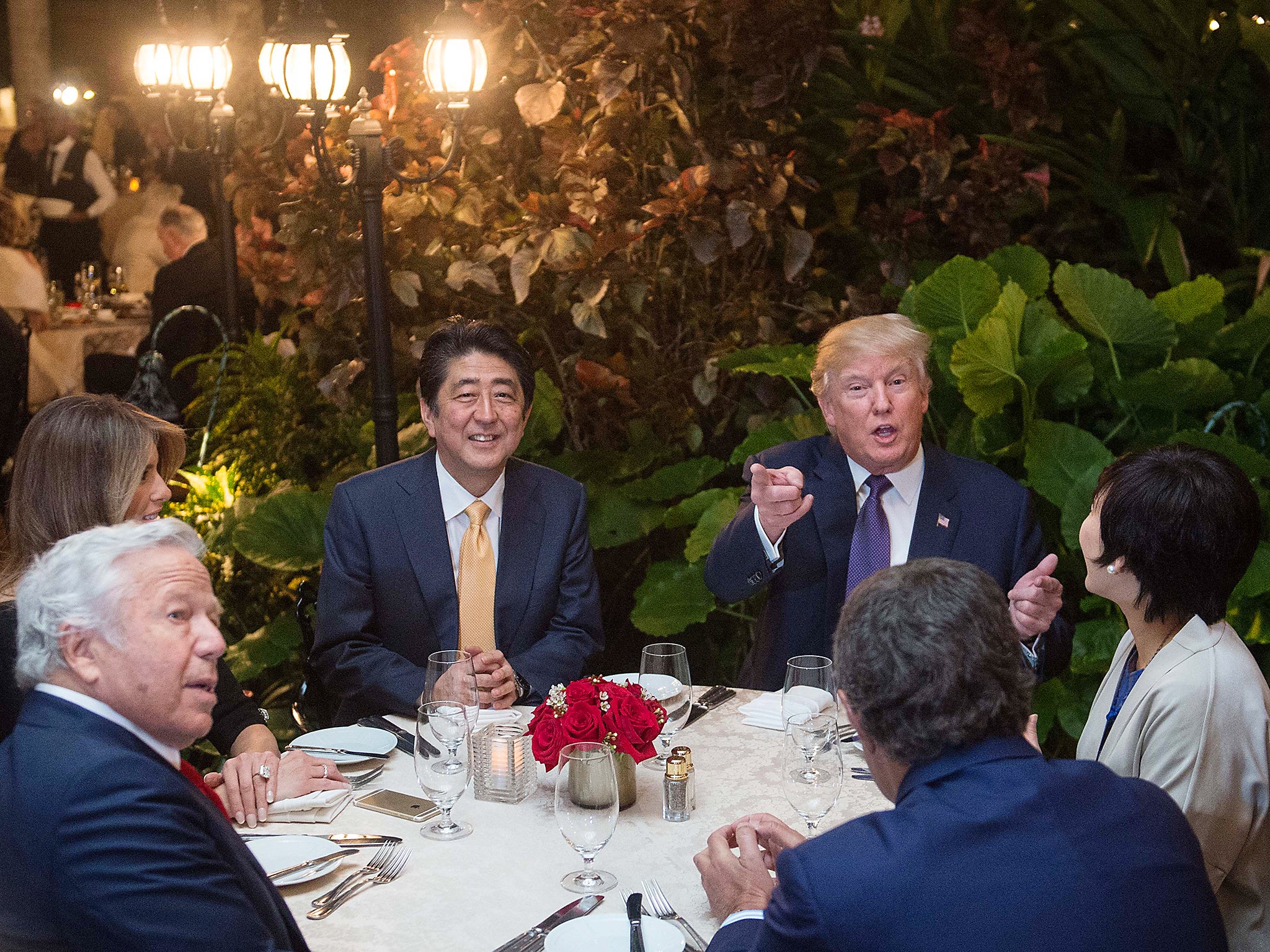 US President Donald Trump, Japanese Prime Minister Shinzo Abe, his wife Akie Abe, US First Lady Melania Trump and Robert Kraft ,owner of the New England Patriots, sit down for dinner at Trump's Mar-a-Lago resort