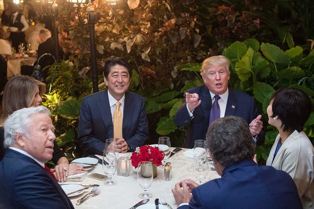 US President Donald Trump, Japanese Prime Minister Shinzo Abe, his wife Akie Abe, US First Lady Melania Trump and Robert Kraft ,owner of the New England Patriots, sit down for dinner at Trump's Mar-a-Lago resort