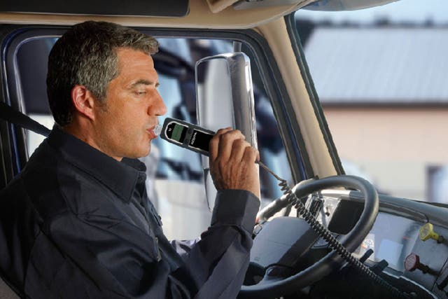 A man uses an in-car breathalyser, which is backed by an EU body