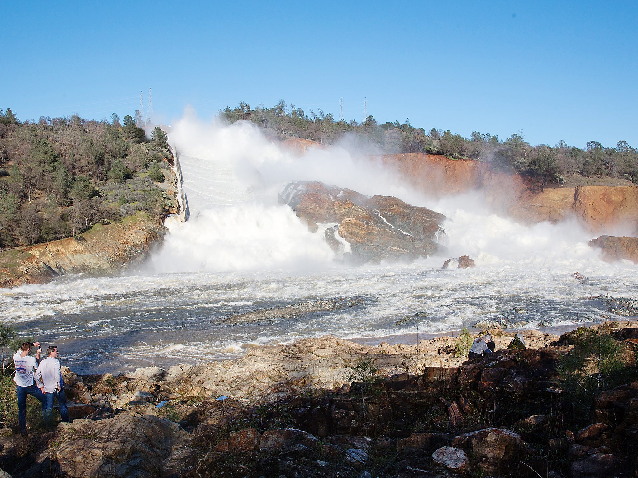 Water cascading into the Feather River from the damaged Oroville Dam spillway in Butte County, USA. Nearly 200,000 people living downstream from the tallest dam in the US were ordered to evacuate their homes over the weekend because an overflow channel appeared to be in danger of imminent collapse