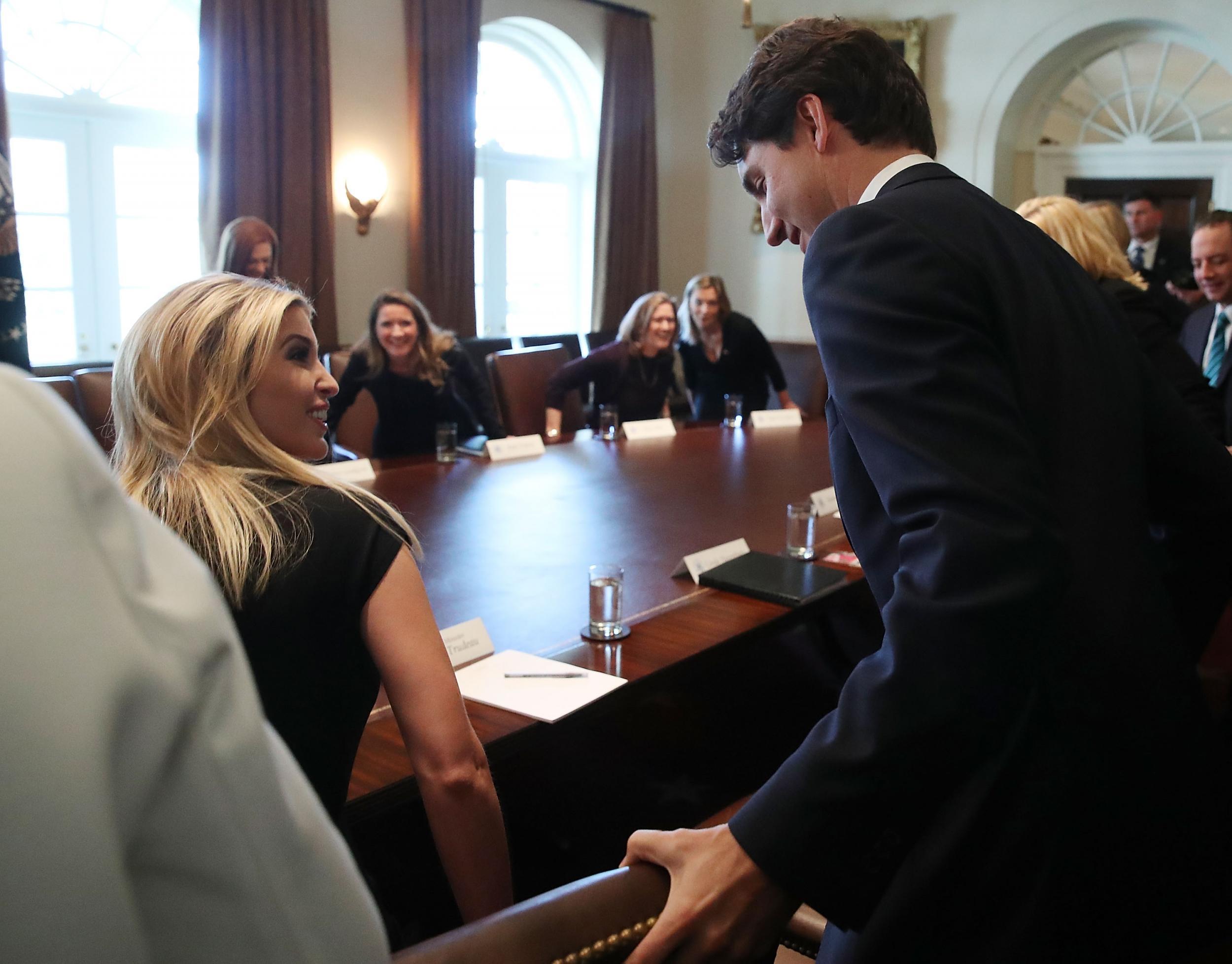 &#13;
Mr Trudeau helps Ivanka Trump with her chair &#13;