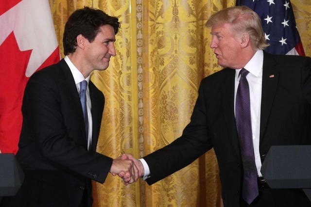 Justin Trudeau shakes hands with Donald Trump
