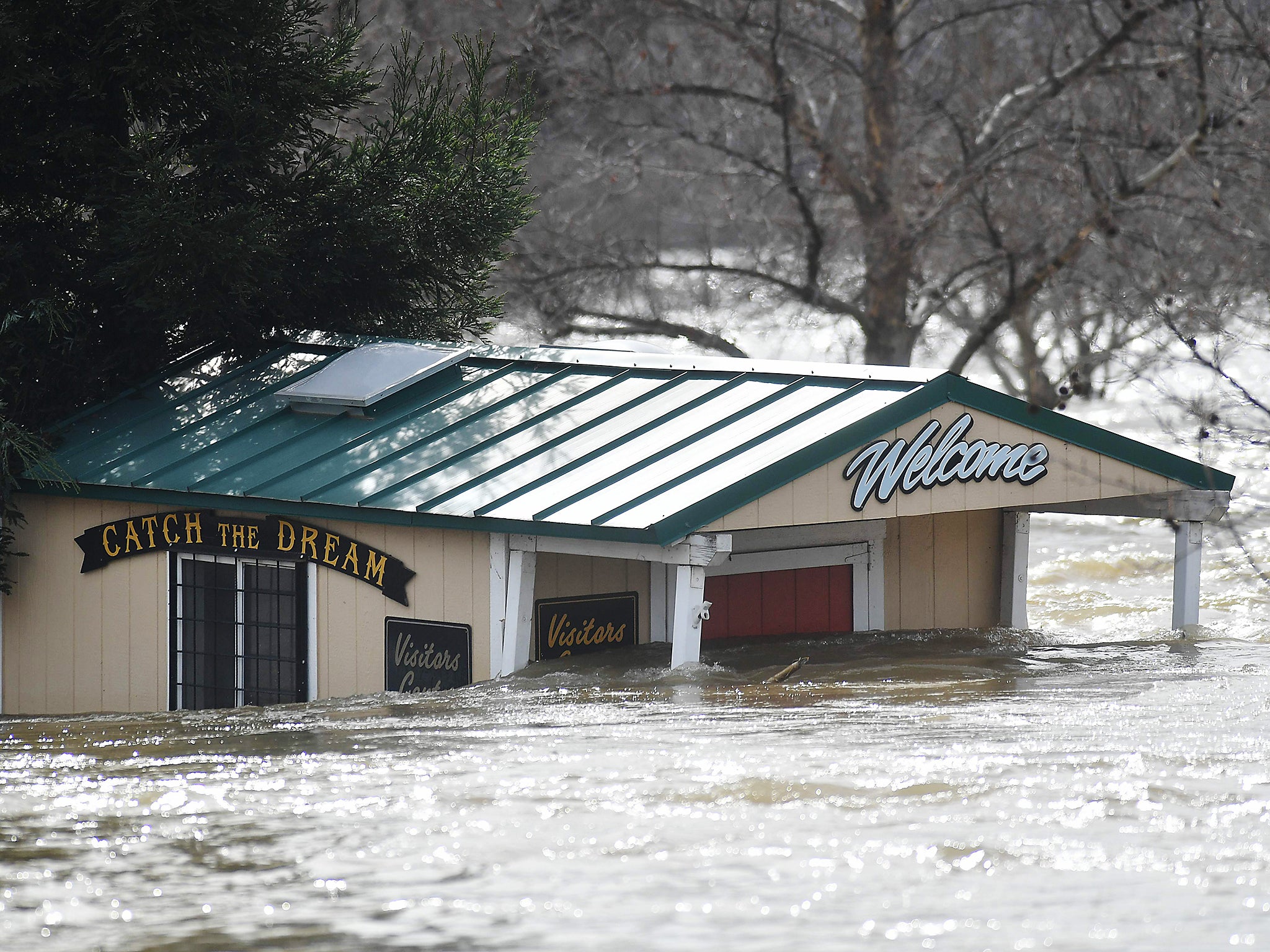 A building is seen submerged in flowing water at Riverbend Park as the Oroville Dam releases water down the spillway as an emergency measure in Oroville, California