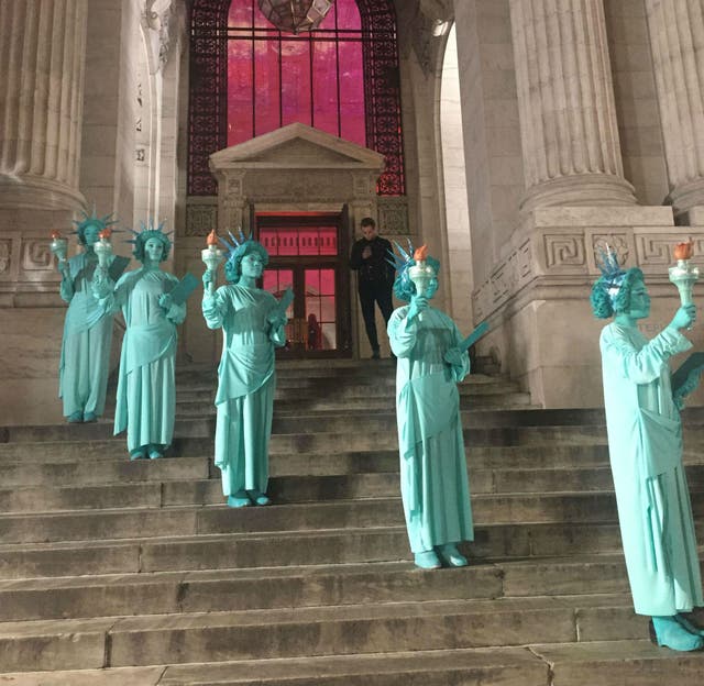 A parade of Lady Liberties outside a fashion week gala for designer Philipp Plein