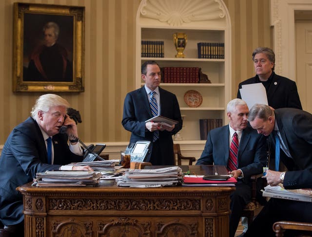 President Donald Trump speaks on the phone with Russian President Vladimir Putin in the Oval Office of the White House