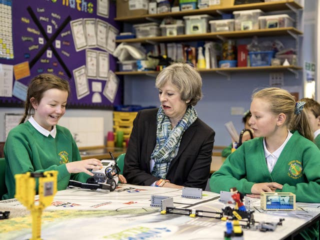 Theresa May sits with year six pupils during a visit to Captain Shaw's Primary School, Bootle