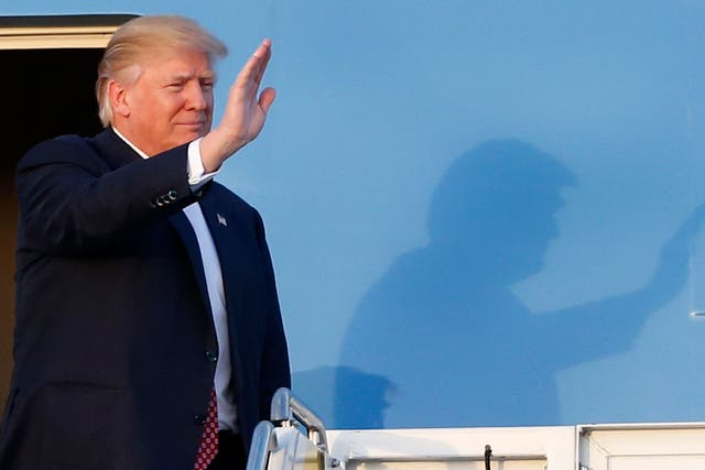 President Donald Trump waves to supporters on the steps of Air Force One