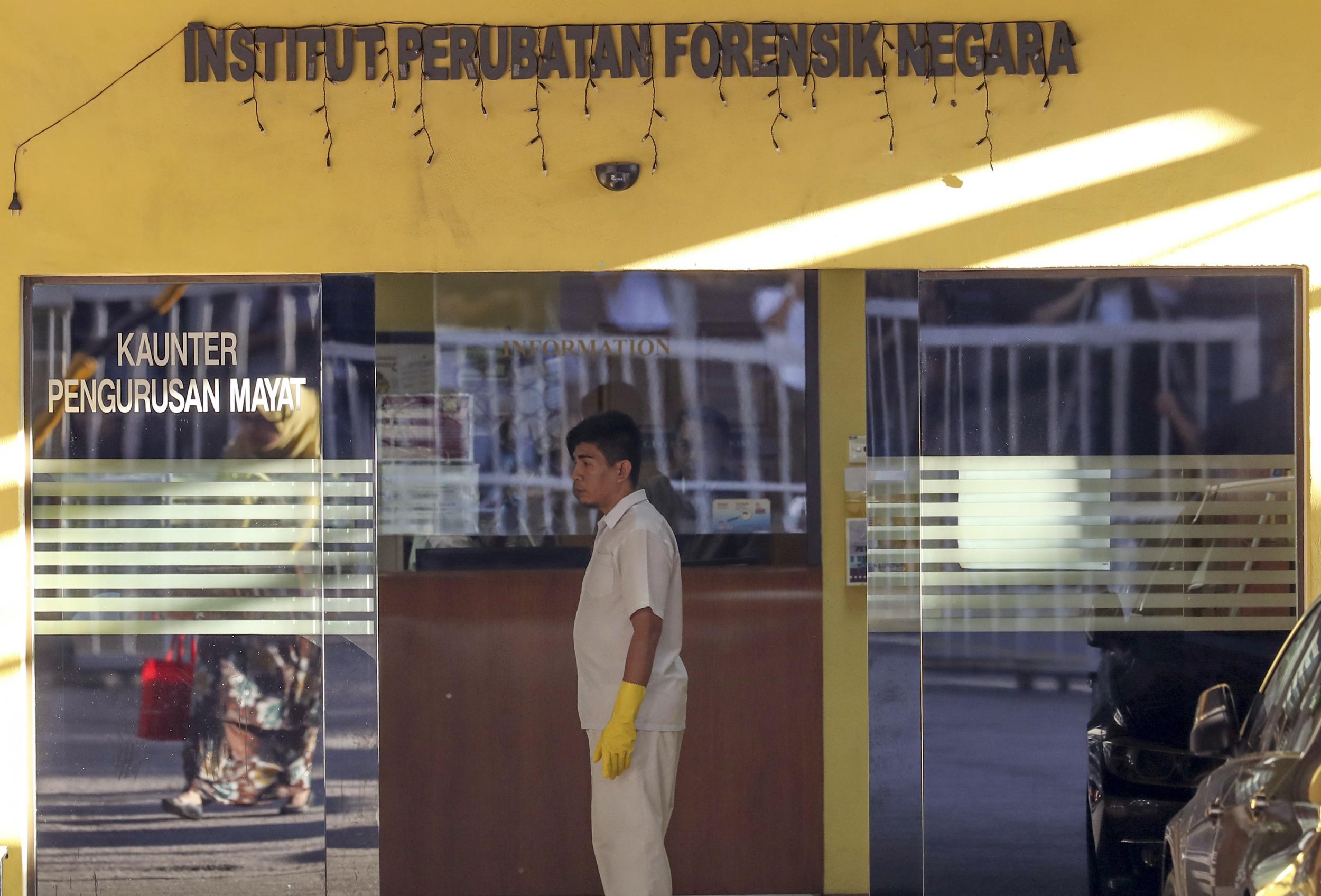 A medical staff member stands at the entrance of the forensic department at a hospital in Kuala Lumpur, Malaysia, where the autopsy of Mr Kim's body was carried out