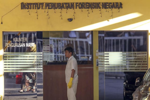  A medical staff member stands at the entrance of the forensic department at a hospital in Kuala Lumpur, Malaysia, where the autopsy of Mr Kim's body was carried out